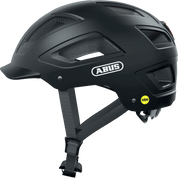Ein schwarzer Abus Hyban 2.0 MIPS-Fahrradhelm mit Mesh-Belüftungseinsätzen, verstellbaren Riemen und einem MIPS-Sicherheitssystem-Logo im hinteren Bereich ist in der Seitenansicht zu sehen.