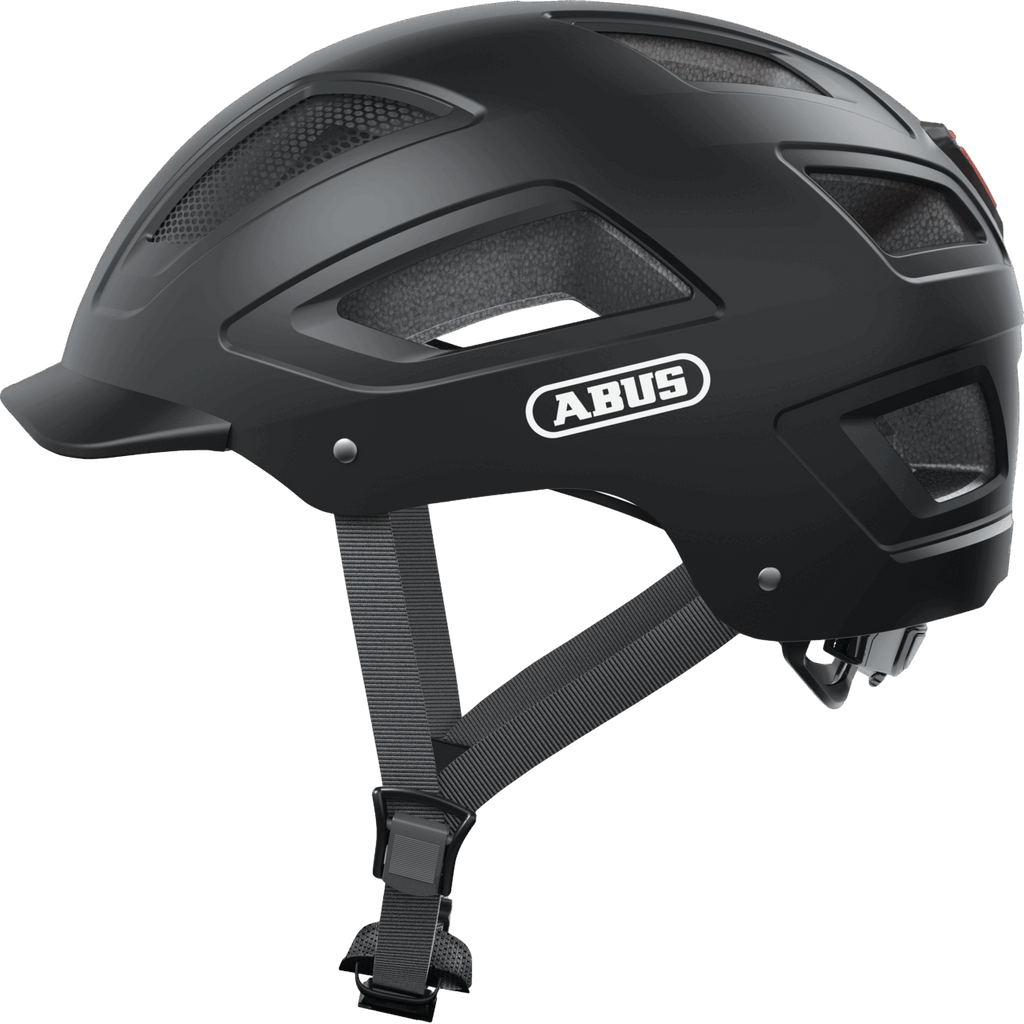 Der von der Seite gezeigte Abus Hyban 2.0 Helm von Abus verfügt über Lüftungsschlitze, einen Kinnriemen mit verstellbarer Schnalle und ein zopf-kompatibles Design.