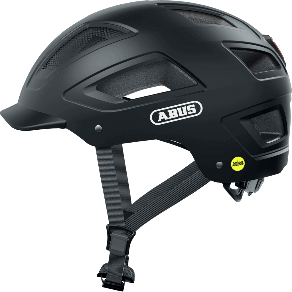 Ein schwarzer Abus Hyban 2.0 MIPS-Fahrradhelm mit Mesh-Belüftungseinsätzen, verstellbaren Riemen und einem MIPS-Sicherheitssystem-Logo im hinteren Bereich ist in der Seitenansicht zu sehen.