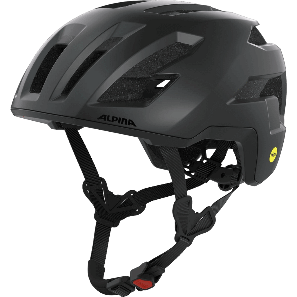 Der Alpina Taunus Gravel Mips, ein mattschwarzer Helm mit Belüftungsschlitzen, verstellbaren Riemen, einem gelben MIPS Safety-System Aufkleber auf der Rückseite und dem Run System Ergo Pro, wird aus einem vorderen Winkel gezeigt.