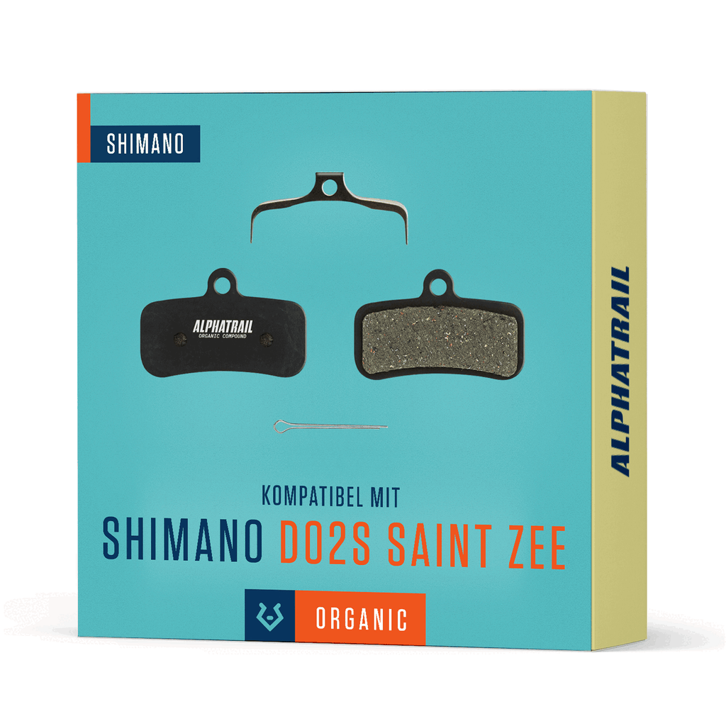 Zee. Beinhaltet zwei Beläge, Metallfeder und Stift. Abgebildet auf blauem Hintergrund mit gelber Verpackung mit blauem und orangem Alphatrail-Branding.